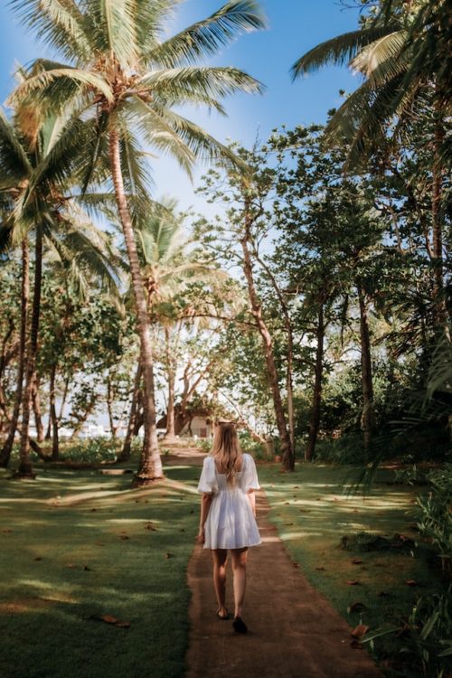 Woman walking on a path on her journey towards finding her purpose